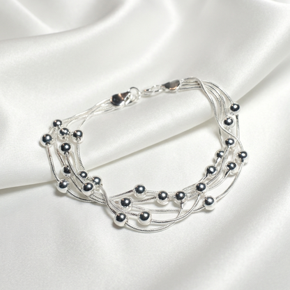 Купити срібний браслет жіночий 925 проба. 20 см, родоване срібло. Безкоштовна доставка. Багатошаровий браслет з срібними кульками.
